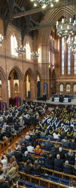 Aerial view of the full audience and graduates inside the church during the ceremony. Aerial view of the full audience and graduates inside the church during the ceremony.
